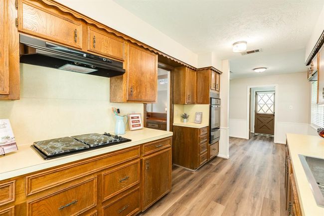 Spacious kitchen with gas range, gas oven w/ warmer, farm style stainless sink and an abundance of counter & cabinets. LVP throughout the living spaces. | Image 17