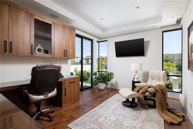 Ideal office with built-ins, custom cabinetry, automatic window and door shades - can also be converted to a 5th bedroom. | Image 20