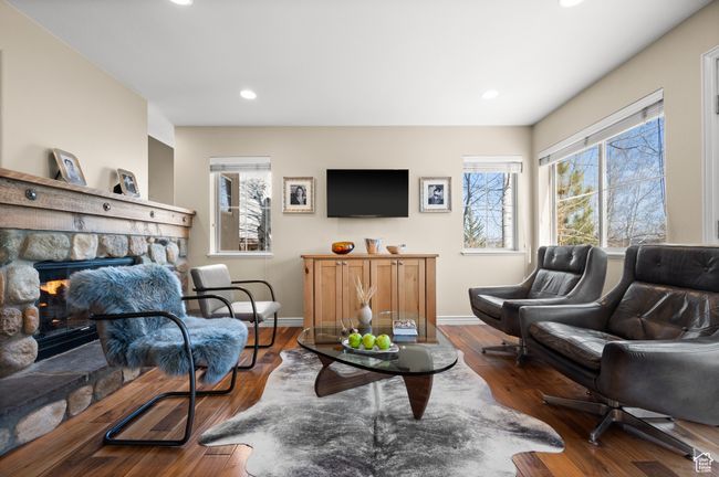 Living area featuring a fireplace, wood finished floors, and recessed lighting | Image 8