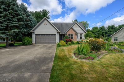 View of front of house featuring a garage and a front yard | Image 1