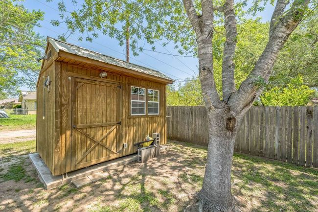View of shed featuring a fenced backyard | Image 7