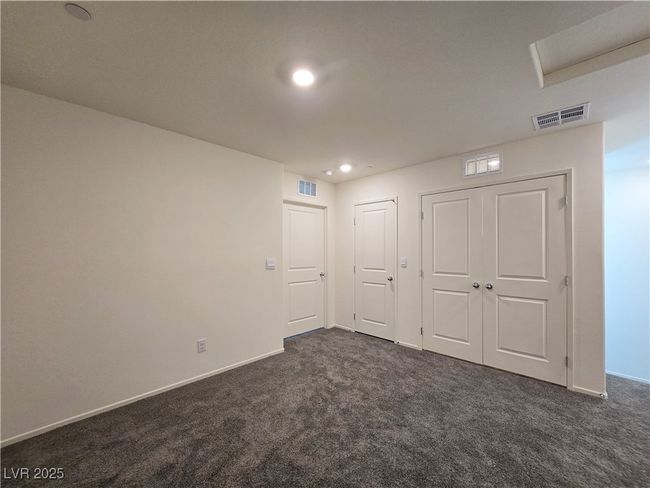 Unfurnished bedroom with dark colored carpet, recessed lighting, and baseboards | Image 17
