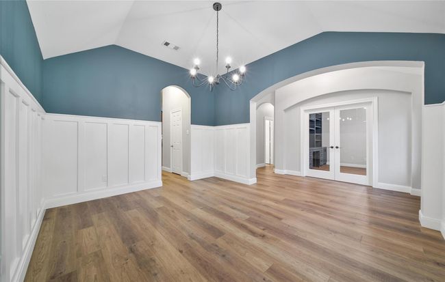 With upgraded lighting, a high ceiling, and two entrances from the kitchen and foyer, this space is ideal for hosting. | Image 4
