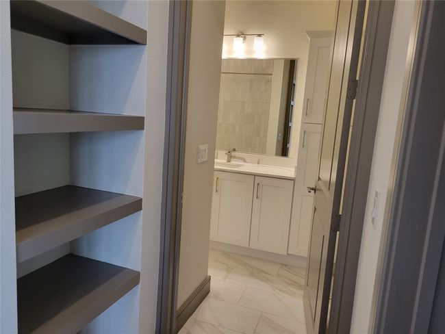 Bathroom featuring vanity and marble look tiles | Image 14