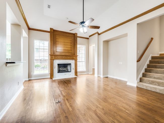 Additional view of spacious family room highlighting the gas fireplace with marble like tile fireplace surround. | Image 12