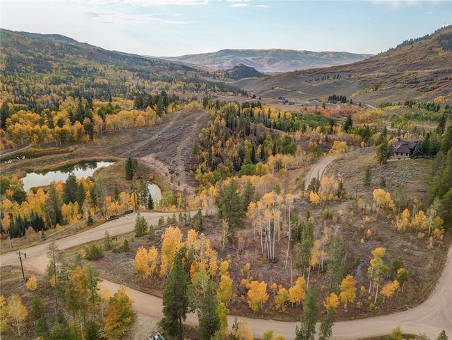 Property view of mountains with a water view and a wooded view | Image 5