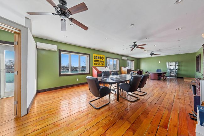 Dining space featuring a wall unit AC and light hardwood / wood-style floors | Image 16