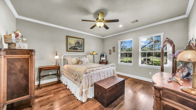 Bedroom with wood finished floors, ornamental molding, recessed lighting, and a ceiling fan | Image 6