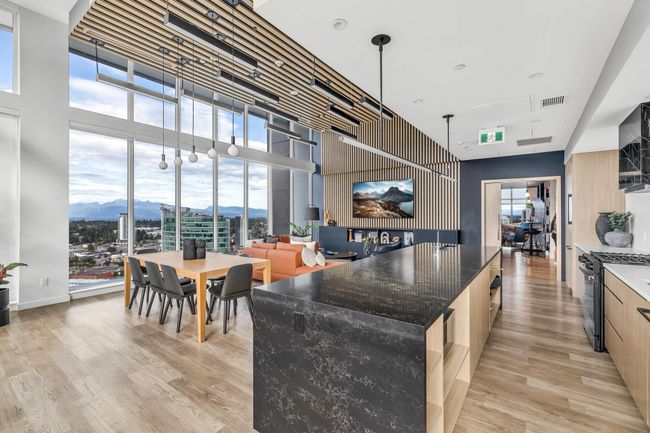 Kitchen with modern cabinets, gas range oven, a high ceiling, floor to ceiling windows, and plenty of natural light | Image 28