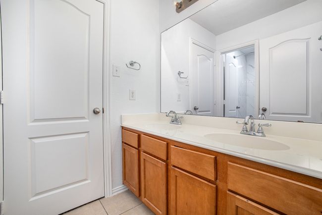 Full bath with tile patterned floors, double vanity, and a sink | Image 25