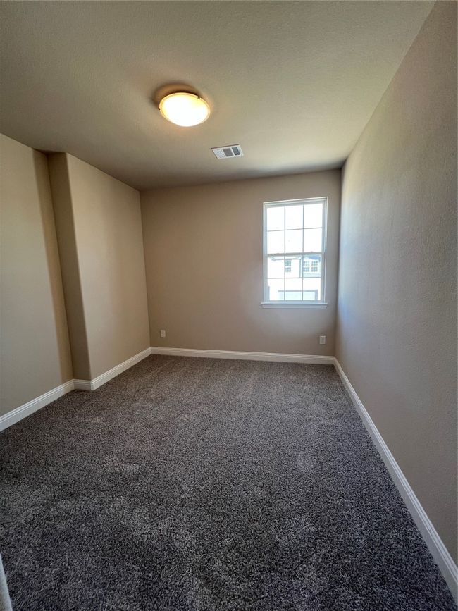 Carpeted spare room featuring baseboards and visible vents | Image 9