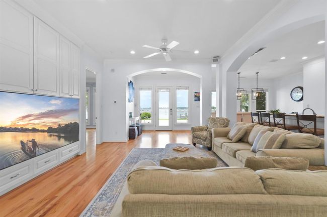 This home features elegant arched doorways and custom open walls, enhancing its spacious and inviting atmosphere. | Image 13