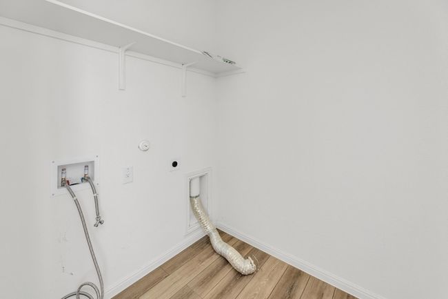 The laundry room offers convenient space for washing and folding, with ample storage for household essentials. | Image 23