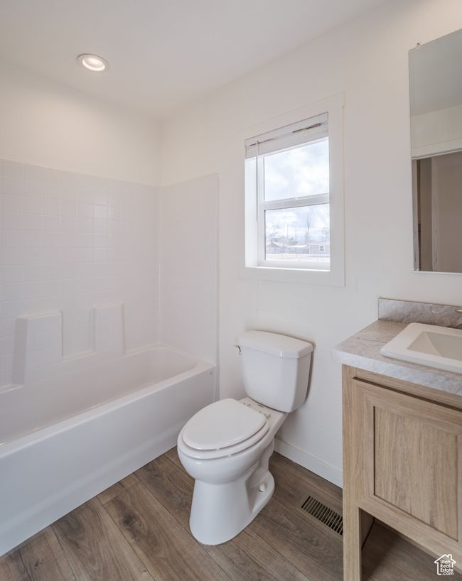 Full bathroom with visible vents, toilet, vanity, and wood finished floors | Image 16