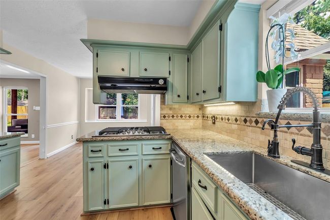 The kitchen features a deep, oversized farmhouse sink for added convenience and style. | Image 22
