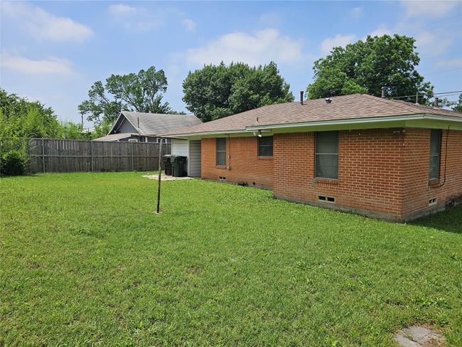Rear view of house featuring brick siding, crawl space, and roof with shingles | Image 13