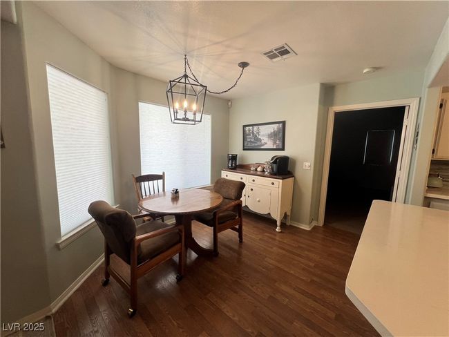 Dining room with a chandelier and dark wood-style floors | Image 26