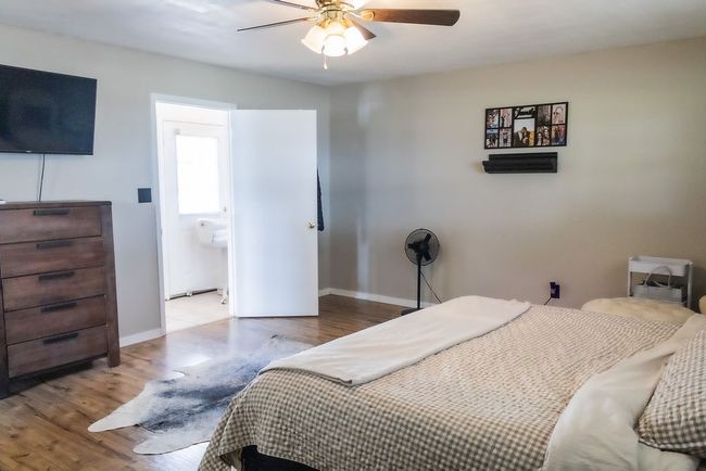 Bedroom with wood finished floors and a ceiling fan | Image 15
