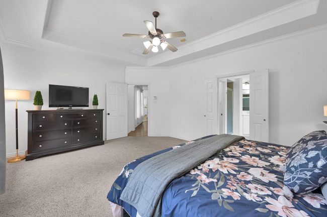 Another angle of the primary, showcasing the generous space. Through the double doors on the right you'll find the primary bathroom. | Image 20