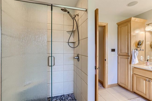 The walk-in shower in the ensuite. Updated glass door and lovely tile floor in the shower. | Image 16