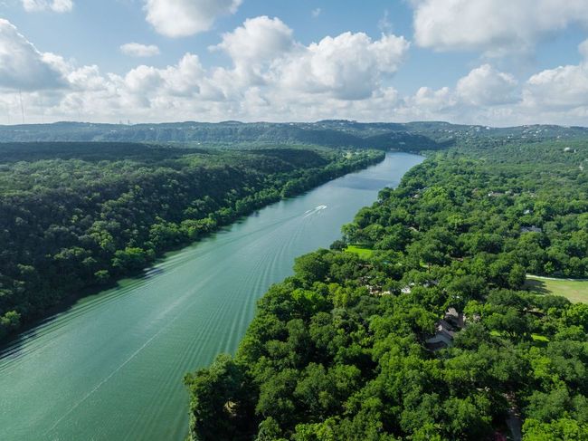 Drone / aerial view of a large body of water and a heavily wooded area | Image 5