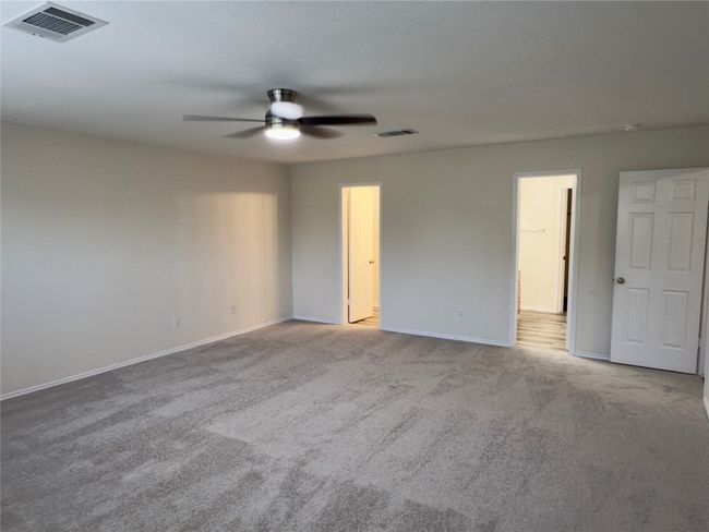 Empty room with ceiling fan and carpet flooring | Image 20