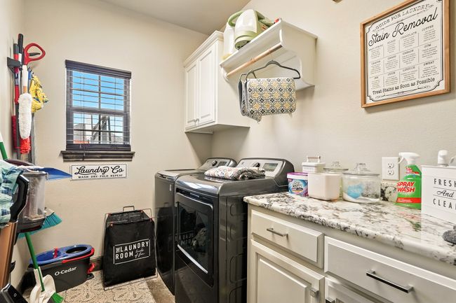 Washroom featuring independent washer and dryer and cabinet space | Image 12