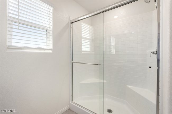 Full bathroom with a shower stall, baseboards, and a healthy amount of sunlight | Image 17