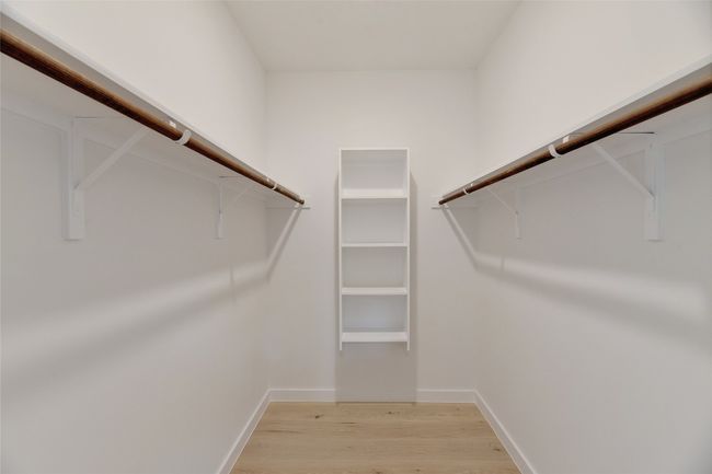 Walk in closet featuring light wood-type flooring | Image 17
