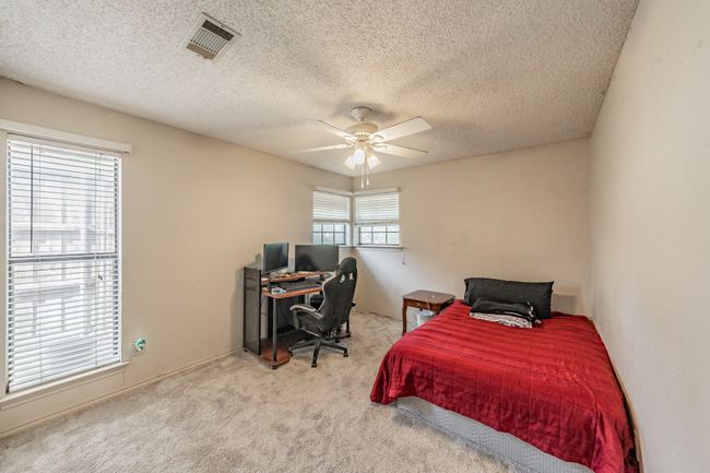 Carpeted bedroom featuring a textured ceiling and a ceiling fan | Image 18