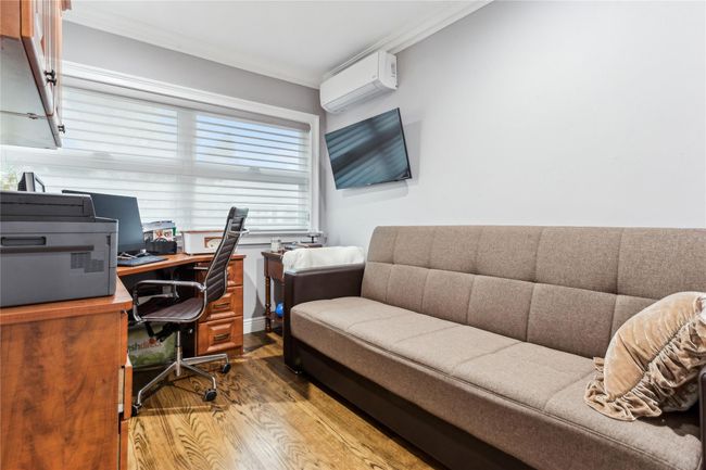Office area with hardwood / wood-style floors, crown molding, and a wall mounted AC | Image 13