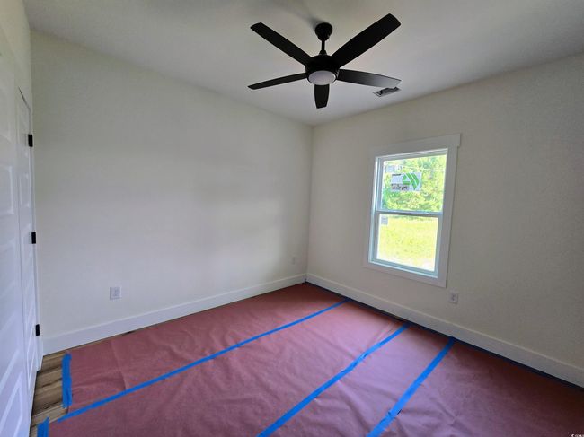 Empty room featuring baseboards and a ceiling fan | Image 28