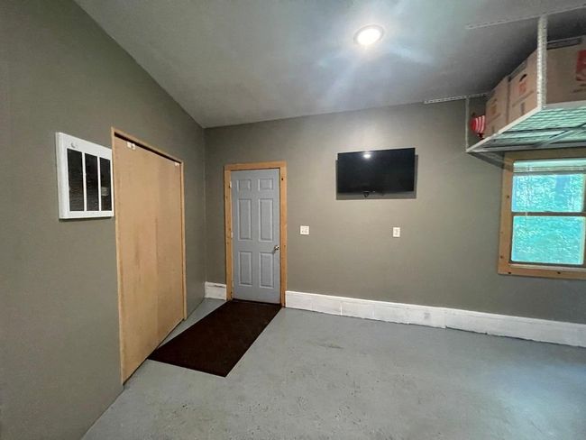 Garage with door access to backyard. | Image 23