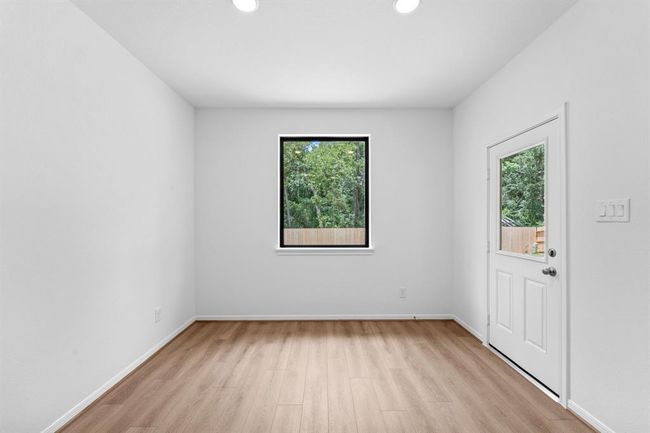 With an abundance of natural light streaming through the windows, the breakfast nook is bathed in a sunny glow, creating the perfect atmosphere to enjoy your morning coffee or a family breakfast. | Image 10