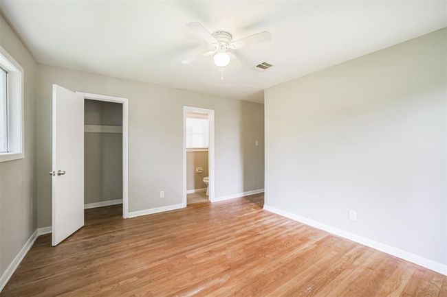 Primary bedroom has half bath and large closet | Image 9