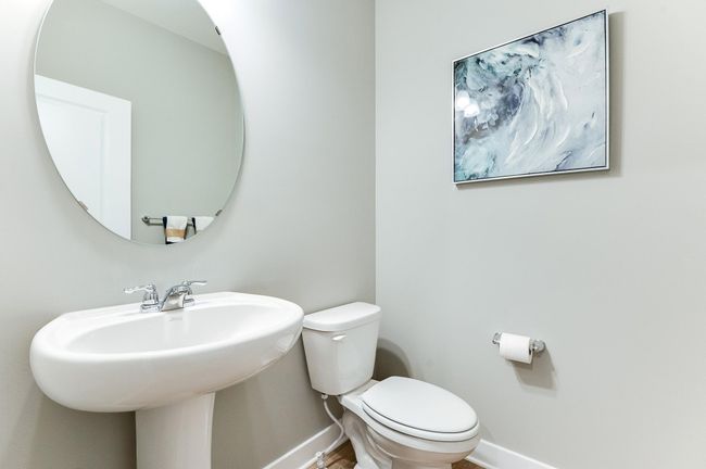 Powder bath is conveniently located on the main level, just tucked away out of the kitchen. Photo of model home, color and options will vary. | Image 21