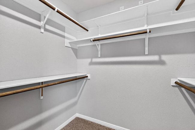 Spacious closet with carpet floors | Image 34