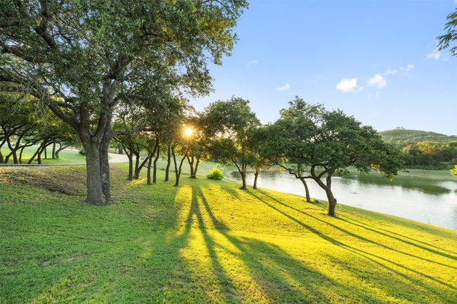 Surrounding community with a water view and a lawn | Image 28