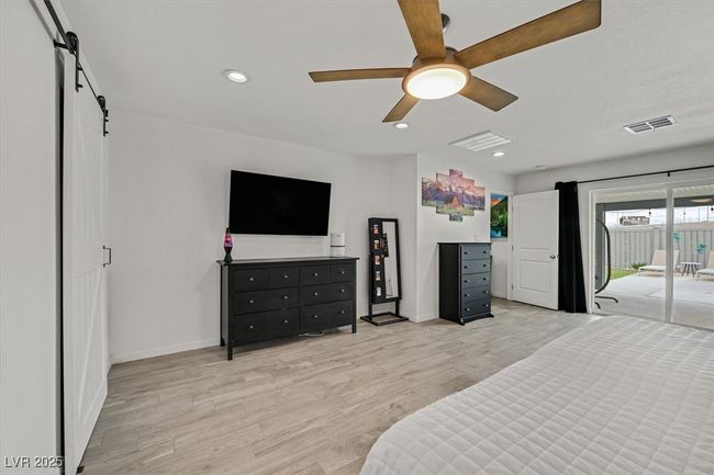 Bedroom featuring visible vents, baseboards, recessed lighting, light wood-style flooring, and access to outside | Image 15