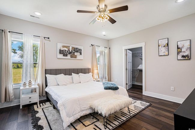 Bedroom featuring dark wood-type flooring, a ceiling fan, recessed lighting, and a spacious closet | Image 11