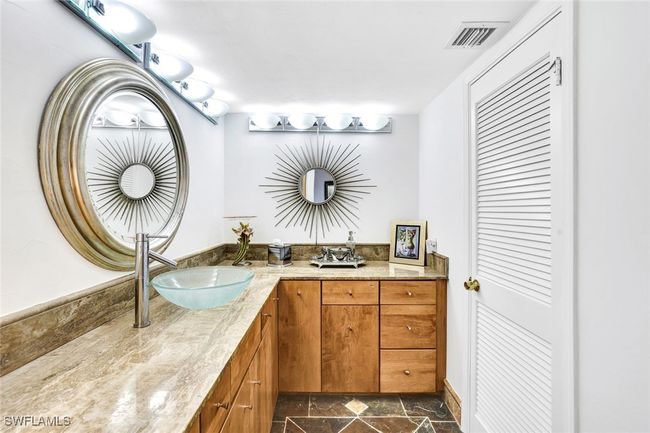 Full bath with stone finish floor, visible vents, a sink, and double vanity | Image 23