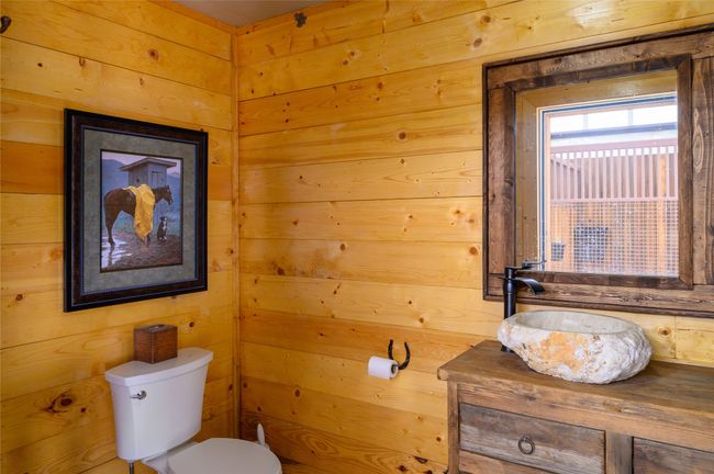 Barn Bathroom with wood finishes and rock basin sink | Image 8