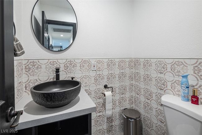 Bathroom featuring vanity, tile walls, and toilet | Image 30