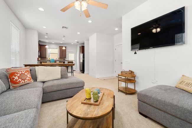 Generous living room separated from bedrooms on a corner with windows on two sides offering a bright, inviting atmosphere that creates a sense of spaciousness | Image 5