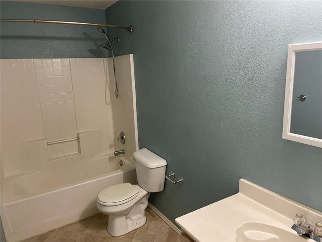 Full bathroom with vanity, shower combination, toilet, and tile flooring | Image 16