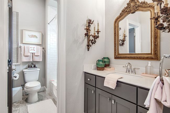 Full bathroom featuring baseboards, toilet, tub / shower combination, vanity, and marble finish floor | Image 31