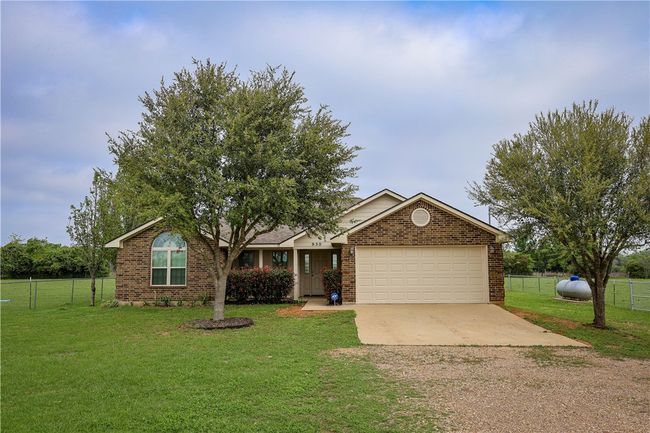 Single story home featuring driveway, a garage, fence, and a front lawn | Image 10