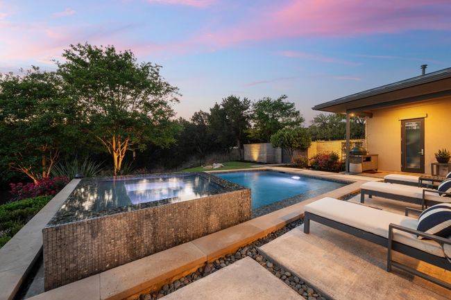 Pool at dusk featuring fence, a fenced in pool, and a patio | Image 31