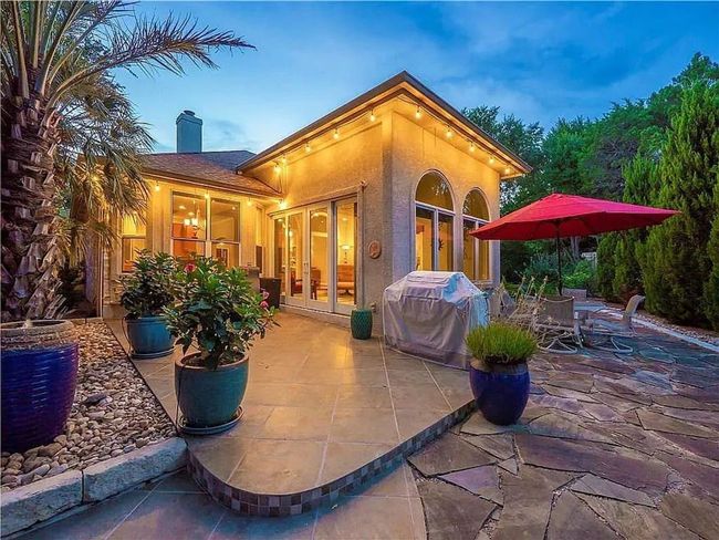 Back of property featuring french doors, a patio, a chimney, and outdoor dining area | Image 33