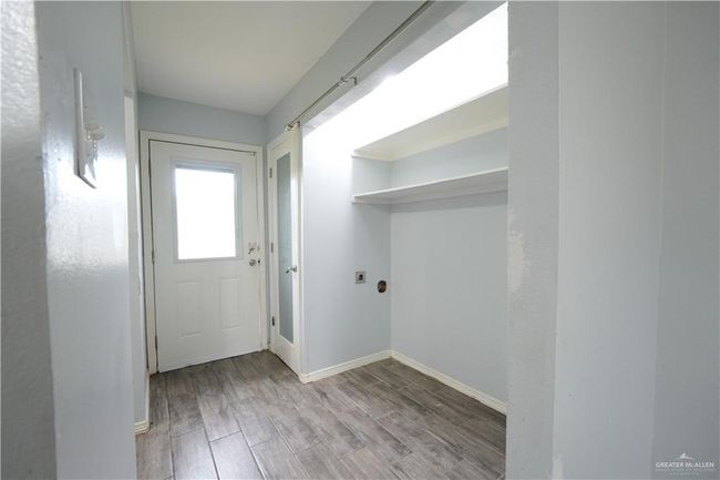 Laundry room featuring wood finished floors | Image 8